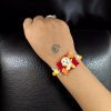 Alt Text: Gold plated Dorami Rakhi for brother.