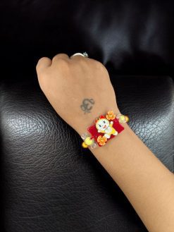 Alt Text: Gold plated Dorami Rakhi for brother.