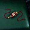 Alt Text: Gold plated Dorami Rakhi for brother.
