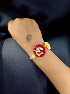 Kids' gold-plated Doll Resin Rakhi.