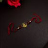 Handcrafted premium gold-plated Ganesha Rakhi for brother.