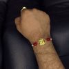 Handcrafted premium gold-plated Ganesha Rakhi for brother.