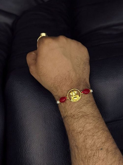 Handcrafted premium gold-plated Ganesha Rakhi for brother.