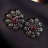 Oxidized silver plated flower stud earrings with stone work