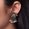 Silver-plated brass peacock stone earrings adorned with colorful stones, perfect for festive occasions