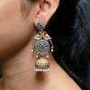 Two-tone parrot earrings with jhumka design, pearl and stone detailing