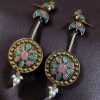 Two-tone traditional bird design dangler earrings with pearl and stone work