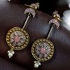 Two-tone traditional bird design dangler earrings with pearl and stone work
