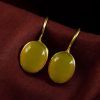 Handmade gold plated hook earrings with Monalisa stone for daily wear.