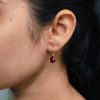 Gold plated drop shape earrings with stone work and hook dangler design