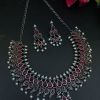 Silver plated leaf design necklace set with stone and pearl work.