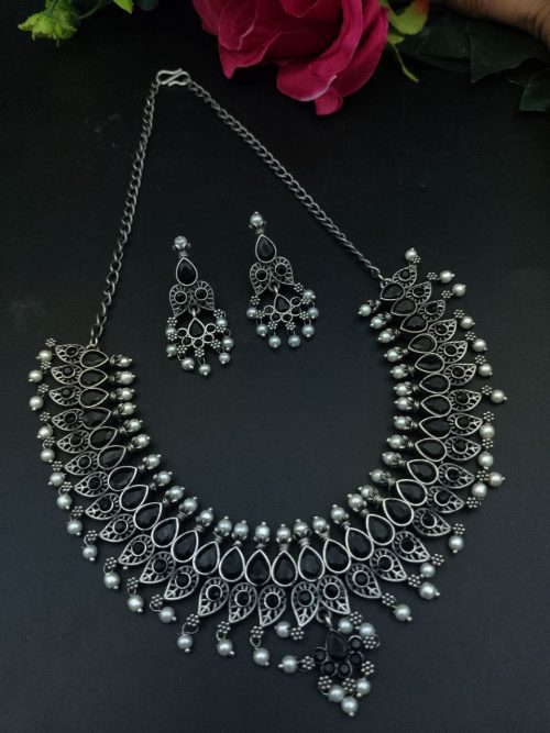 Silver plated leaf design necklace set with stone and pearl work.