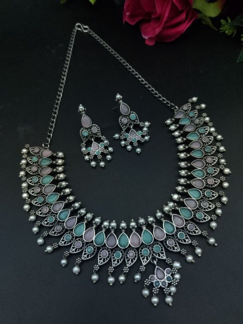 Silver plated leaf design necklace set with stone and pearl work.