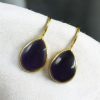 Gold-plated ethnic drop shape dangler earrings with hook style