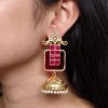Gold plated floral art jhumka earrings with Monalisa stone and pearl work