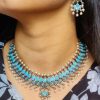 Silver plated leaf design necklace set with stone and pearl work.