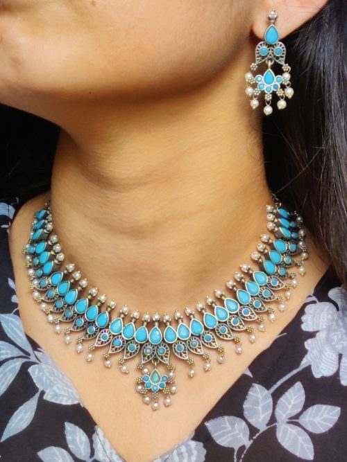 Silver plated leaf design necklace set with stone and pearl work.