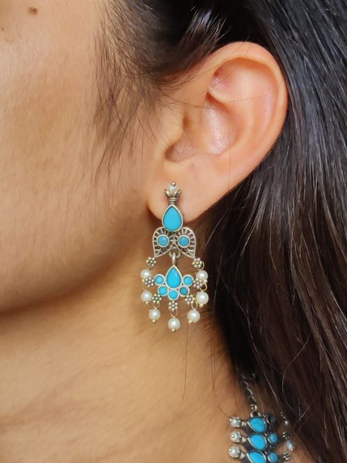 Silver plated leaf design necklace set with stone and pearl work.