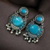 Oxidized silver plated floral earrings with pearl work and Monalisa stone.