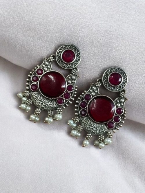 Oxidized silver plated floral earrings with pearl work and Monalisa stone.