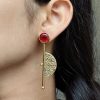 Gold plated half circle earrings with floral art and stone work