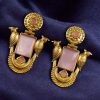 Traditional gold plated earrings with bird design and green stones in vintage style.