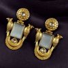 Traditional gold plated earrings with bird design and green stones in vintage style.