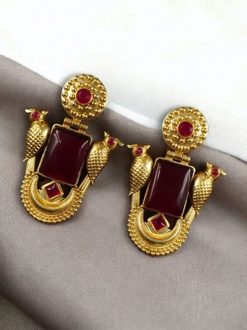 Traditional gold plated earrings with bird design and green stones in vintage style.