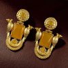 Traditional gold plated earrings with bird design and green stones in vintage style.