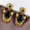 Traditional gold plated earrings with bird design and green stones in vintage style.