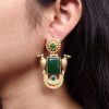 Traditional gold plated bird earrings with design and green stones in vintage style.