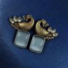 Two-tone peacock earrings with stone work in traditional look alike design.