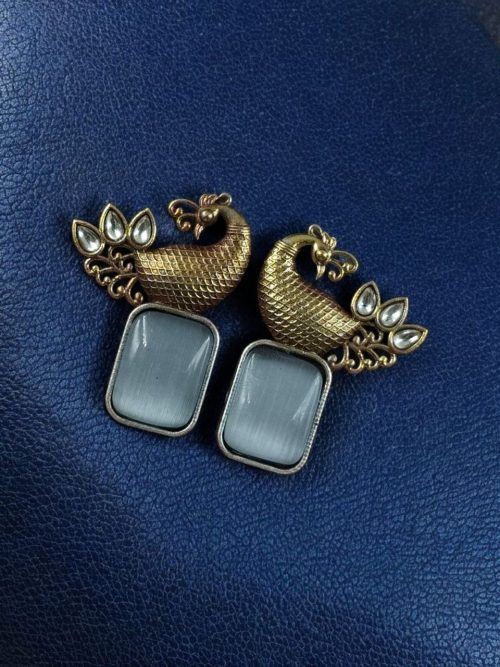 Two-tone peacock earrings with stone work in traditional look alike design.