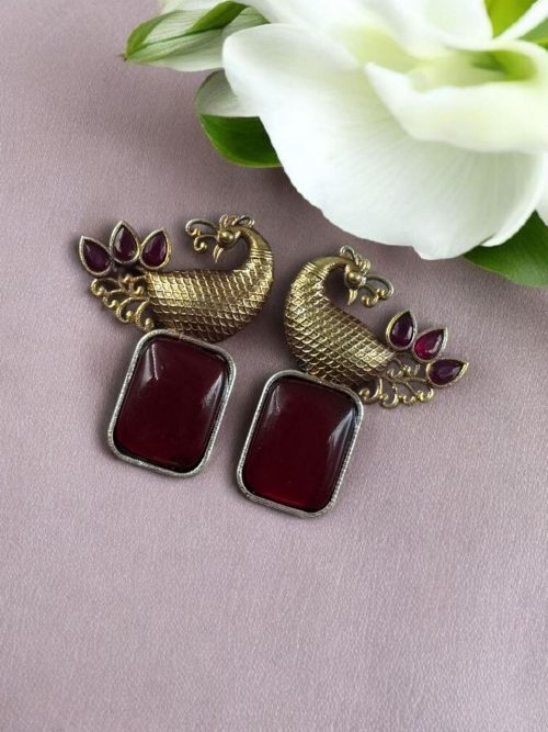 Two-tone peacock earrings with stone work in traditional look alike design.