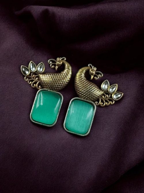 Two-tone peacock earrings with stone work in traditional look alike design.