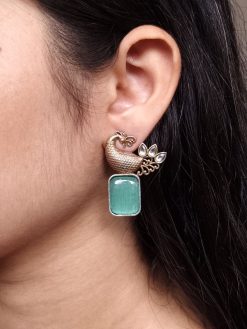 Two-tone peacock earrings with stone work in traditional look alike design.