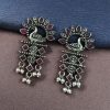 Brass peacock earrings with intricate design, lightweight and elegant