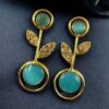 Gold plated floral art earrings with Monalisa stone and leaf design for ethnic and western wear.
