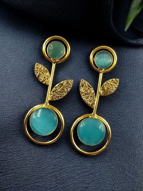 Gold plated floral art earrings with Monalisa stone and leaf design for ethnic and western wear.