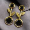 Gold plated floral art earrings with Monalisa stone and leaf design for ethnic and western wear.