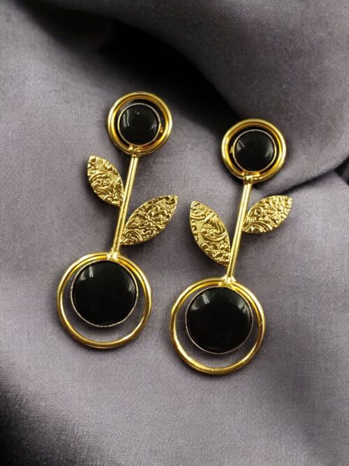 Gold plated floral art earrings with Monalisa stone and leaf design for ethnic and western wear.