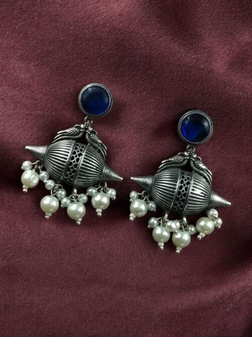 Traditional oxidized silver replica peacock earrings with pearl and stone work.