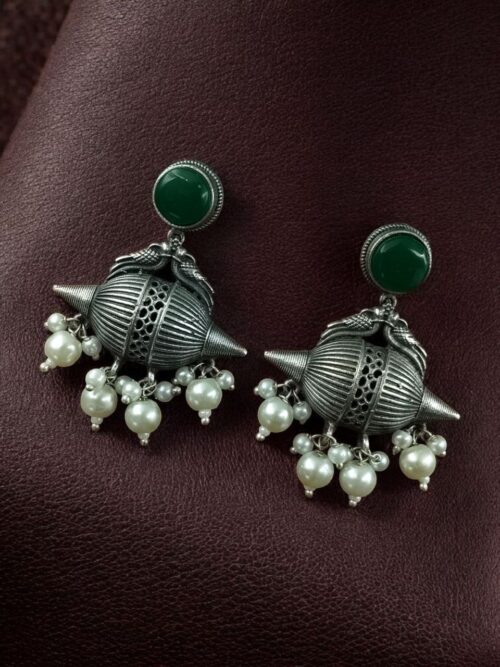 Traditional oxidized silver replica peacock earrings with pearl and stone work.