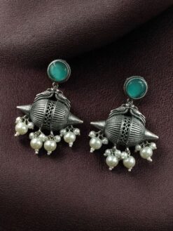 Traditional oxidized silver replica peacock earrings with pearl and stone work.