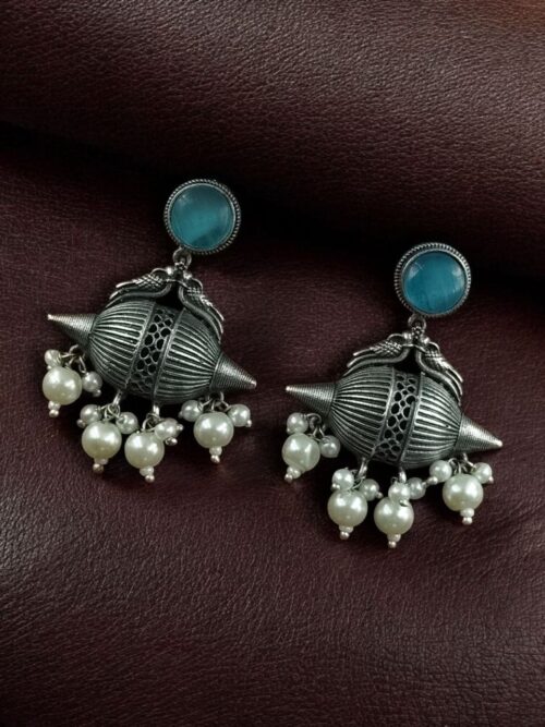 Traditional oxidized silver replica peacock earrings with pearl and stone work.