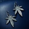 Oxidized silver plated long leaf hook dangler earrings for women.