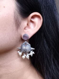 Traditional oxidized silver replica peacock earrings with pearl and stone work.