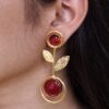 Gold plated floral art western look earrings with Monalisa stone and leaf design for ethnic and western wear.