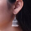Oxidized German silver pearl work jhumka earrings in hook dangler design.