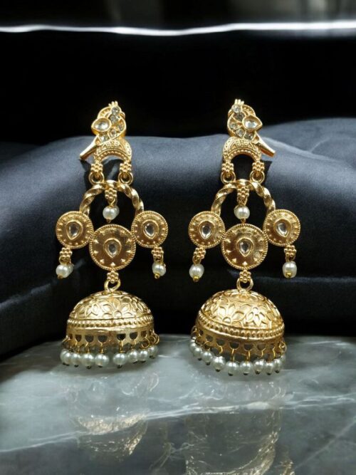 Gold plated bird dangler earrings with pearl and stone work.